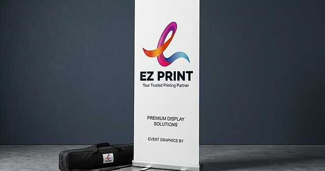 Illustration of two pull-up banner stands with blank blue graphics in an empty room.
