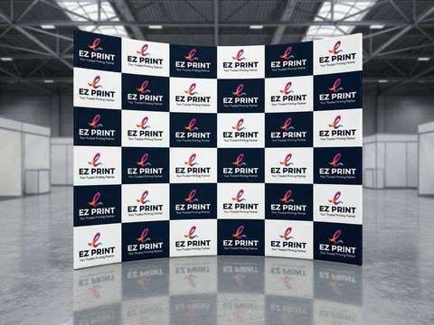 A curved tension fabric exhibition media backdrop with checkerboard EZ Print branding in an exhibition hall.