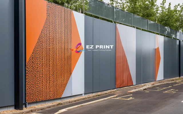 Printed hoarding graphics and panels installed on a site boundary wall, with the EZ Print logo.